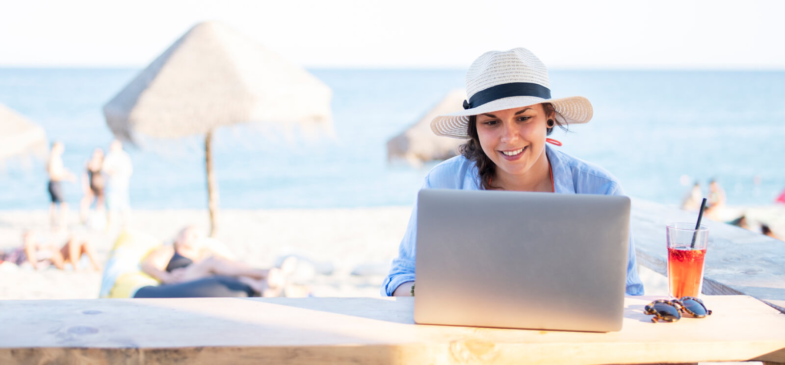 Woman using a laptop on a beach