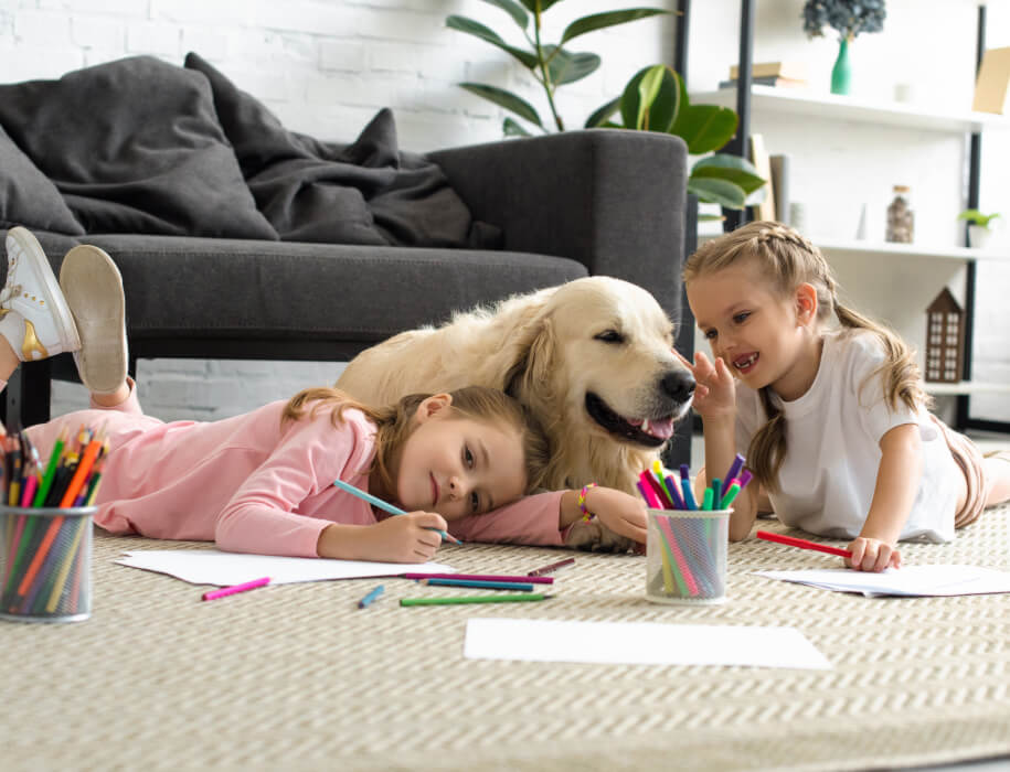 young kids coloring with a dog