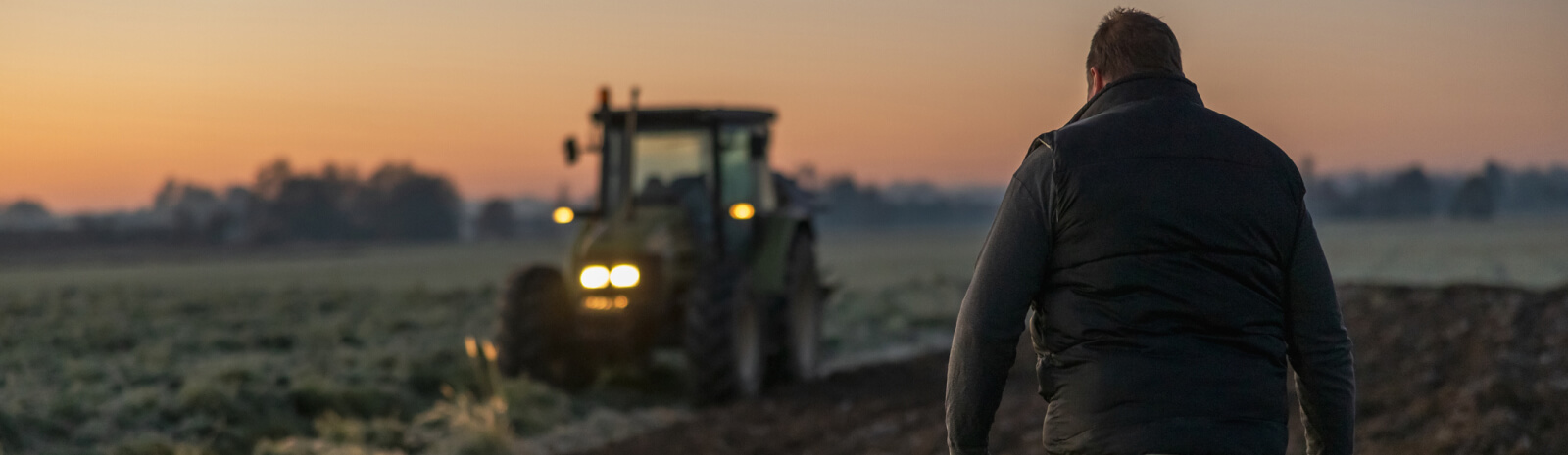 Farmer walking towards a tractor